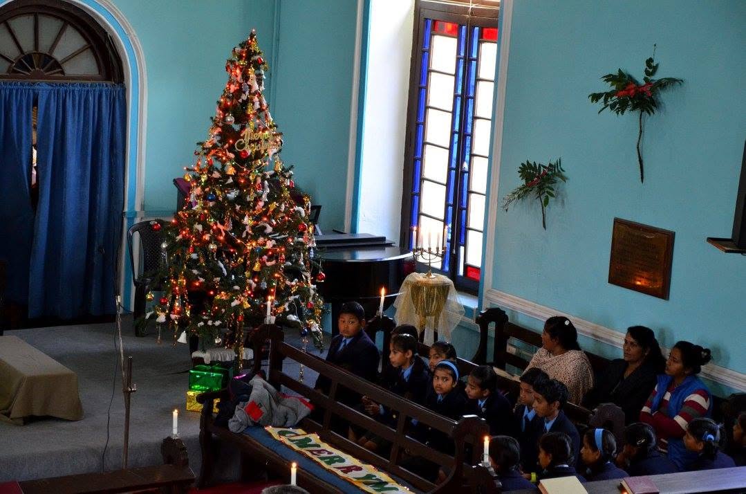 Christmas tree and candlelight inside Union Church during the Sunday School Christmas service